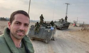 Israeli reservist with armored vehicles in the field